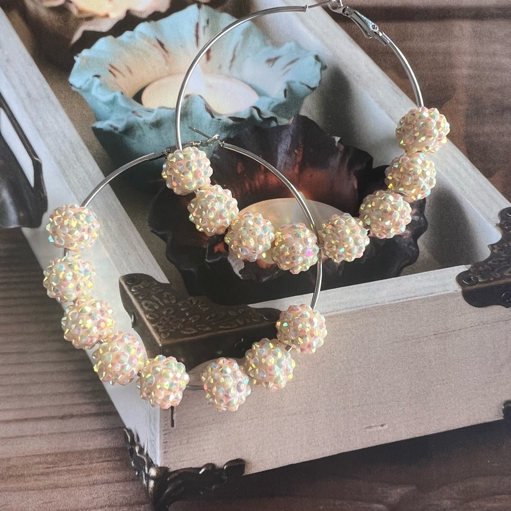 Silver hoop earrings with yellow iridescent balls